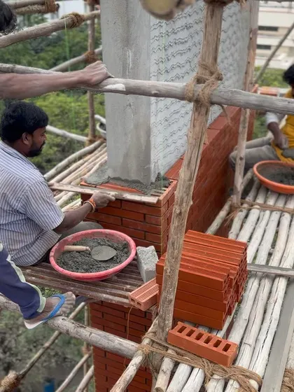 A series showing masons meticulously laying bricks for a facade. Achieving a perfect finish requires incredible skill and patience, and we have immense respect for the craftspeople who bring our designs to life.