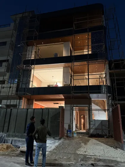 Discussing the final exterior details with my team on-site at the Noida house. We are getting close to finishing the facade work.