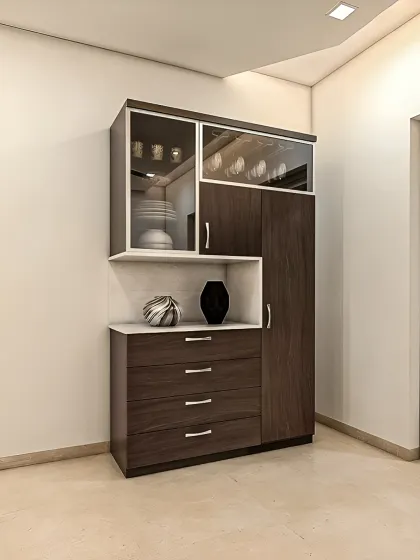 A freestanding crockery unit in a dark wood finish with white accents. This compact piece offers a combination of drawers, closed cabinets, and glass-front display sections.