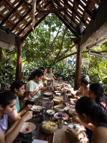 Another view of our community meal, showcasing the beautiful, nature-filled setting of our dining area. Eating mindfully in a calm environment is a key part of the experience we cultivate at Natureville.