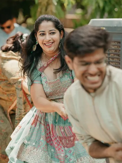 The competitive spirit and joy are evident on the guests' faces as they pull with all their might in the tug-of-war.