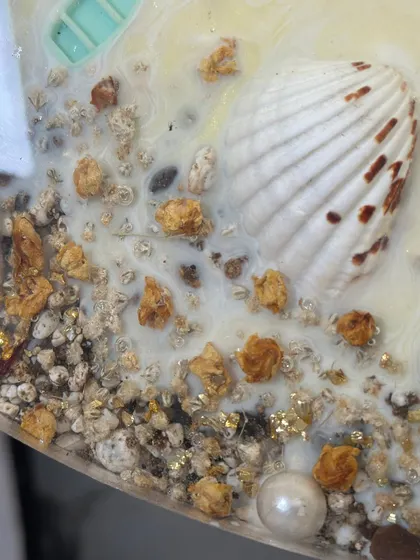 The beauty is in the details. Here you can see a shell with a pearl inside, nestled within the preserved varmala on the beach table.