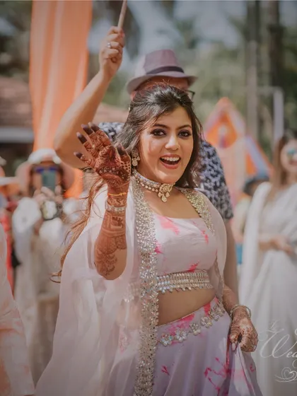 The bride, with her beautiful Mehendi, making a cheerful entrance.