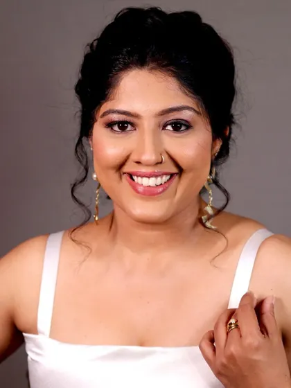 A smiling close-up of the actress, looking radiant and confident.