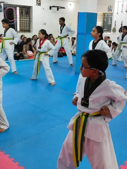 A view from the back of a class of yellow and green belts.