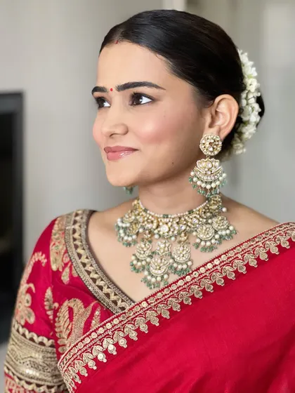 Another angle showing the beautiful gajra in her hair and the soft, clean makeup. This look is all about celebrating natural beauty.