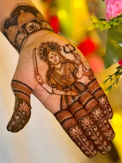 A clear, stunning portrait of the goddess Dashama on the palm, holding her sword and trident. The lotus patterns on the fingers complement the divine figure.