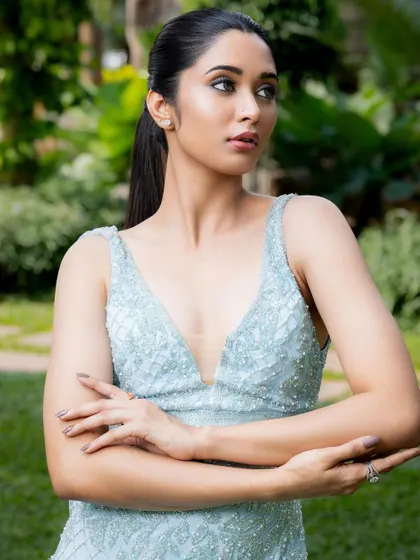 A poised and elegant shot in the light blue gown. The plunging neckline and detailed bodice make it a sophisticated choice for any formal event.