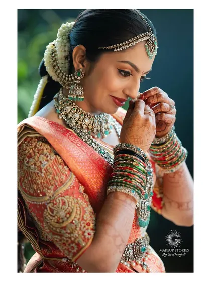 A candid moment of the bride adjusting her nose ring. My makeup is designed to be flawless yet allow for natural movement and expression throughout the day.