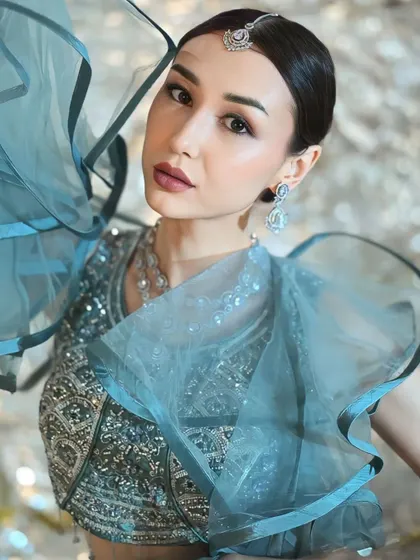 A close-up on the stunning details of the blouse and the ruffled sleeves. This is the kind of unique piece that makes a portfolio stand out.