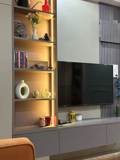 A close-up of the backlit open shelving, perfect for displaying books, photos, and other personal items.