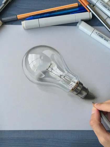 This is a realistic drawing of a light bulb. Capturing the transparency of the glass and the intricate detail of the filament inside is a delicate process that requires a steady hand.