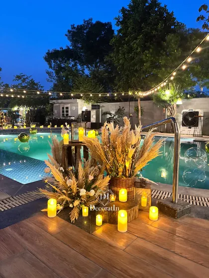 The poolside corner at dusk, with the string lights above and the glowing candles creating a perfect transition from day to night.