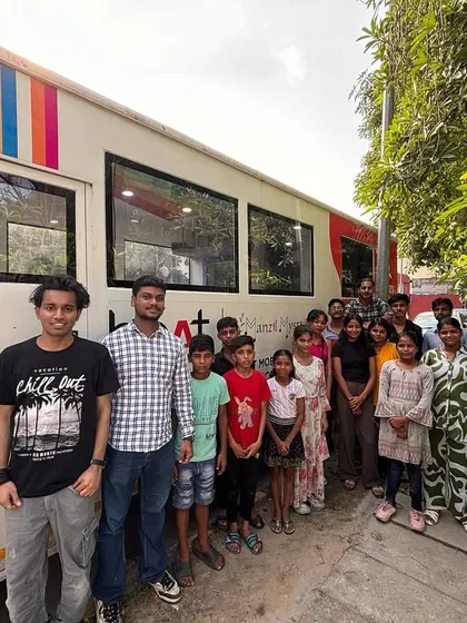 A side view of the Music Bus with our students and facilitators. The vibrant artwork on the bus reflects the creativity and energy we bring to every location we visit.