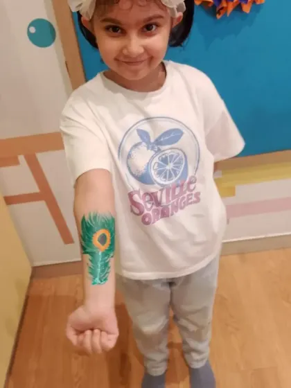 A proud guest displaying her festive arm art. Our tattoo corner is always a busy and happy spot at any party.