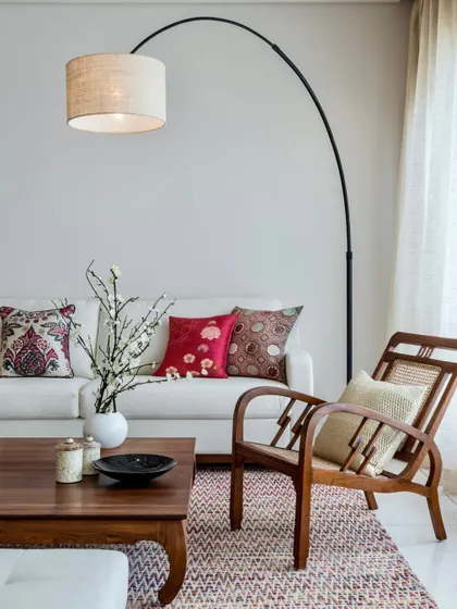 A closer look at the seating in the Terrazzo Residence, where a classic wooden chair with cane detailing sits beside a contemporary sofa. This mix of styles creates a layered and timeless interior.