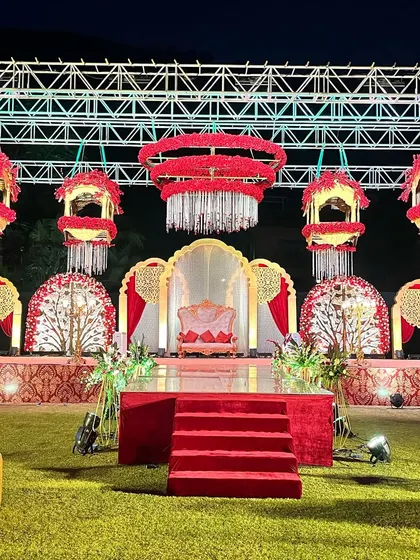 A magnificent stage setup for a pre-wedding function, featuring hanging floral chandeliers and peacock-inspired backdrops. This showcases our ability to create grand, thematic decor for any event.