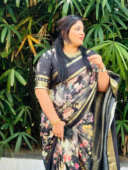 Another view of the client in her black floral saree, showing how the light and airy fabric moves.
