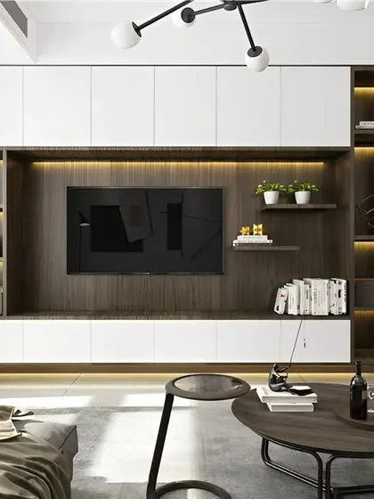 A great example of a complete living room setup, this space features a modern TV unit with integrated shelving and cabinets. The design balances dark wood with white finishes, creating a sophisticated and organized entertainment area.