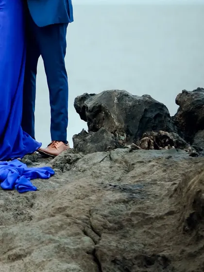 A detail shot showing the base of the gown on the rocks.
