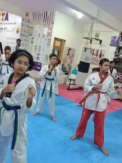 Senior students, including red and black belts, demonstrate advanced forms.