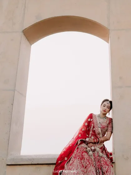 A serene portrait of the bride resting in an archway, a moment of quiet contemplation.