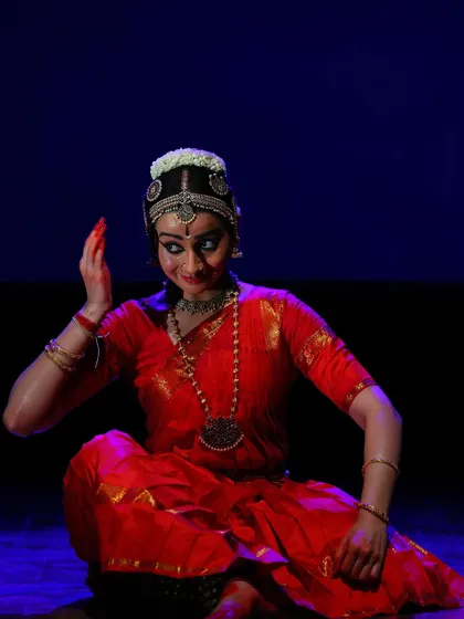 A seated abhinaya pose, where I am narrating a story about the Lord's greatness. The expression of wonder and respect is central to this piece.