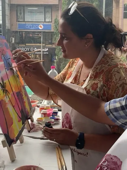 A couple enjoying a creative date night at our studio. It's a great way to break from the routine and try something new together.