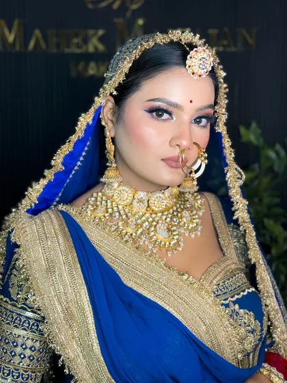A confident portrait of the Rajputi bride, looking directly at the camera.