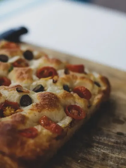 The rich, golden-brown crust of a freshly baked focaccia.