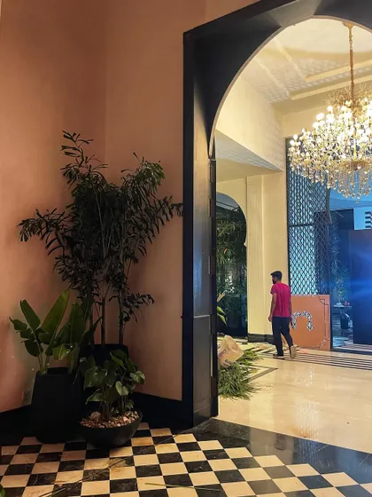 Another glimpse from the "Call Me Bae" set. The arched doorway and checkerboard floor are perfectly complemented by the lush green plant cluster we designed.
