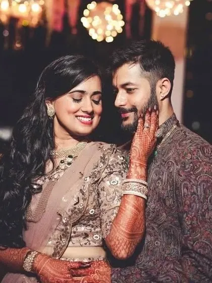 A sweet moment captured. I designed these complementary outfits for an engagement or sangeet, with her soft-hued lehenga and his richly textured sherwani.