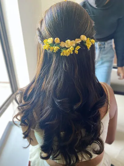 Another angle of the floral half-updo, showing how it elegantly frames the face.