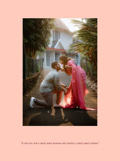 A classic romantic gesture with the groom-to-be on one knee, kissing his partner's hand.