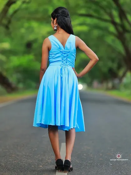 A back view of our sky blue short frock, featuring a stylish and adjustable lace-up detail.