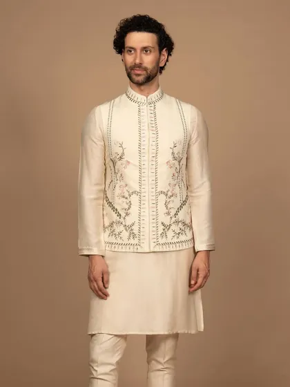 This embroidered Jawahar jacket in a soft ivory hue whispers of heritage. The delicate floral embroidery is a story in itself, crafted from luxurious fabric for a feeling of pure sophistication.