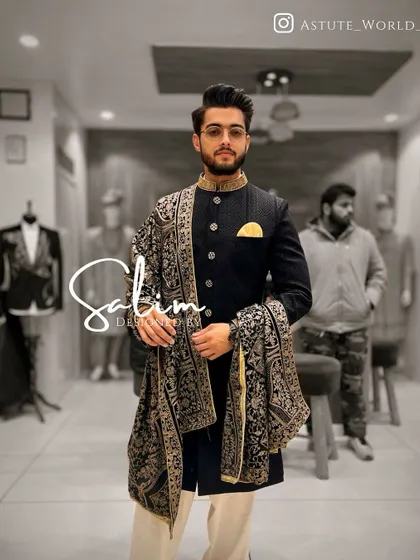 A client wearing a black Indo-Western jacket with a matching embroidered pashmina shawl. This is a perfect example of how I style a complete, cohesive look.