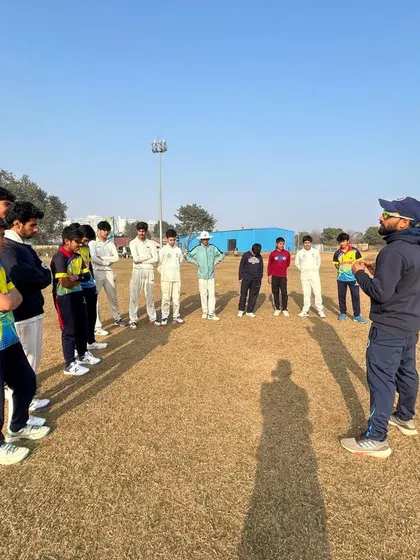 A coach provides instructions to a group of young players. We foster an environment where players are encouraged to ask questions and engage deeply with the learning process.