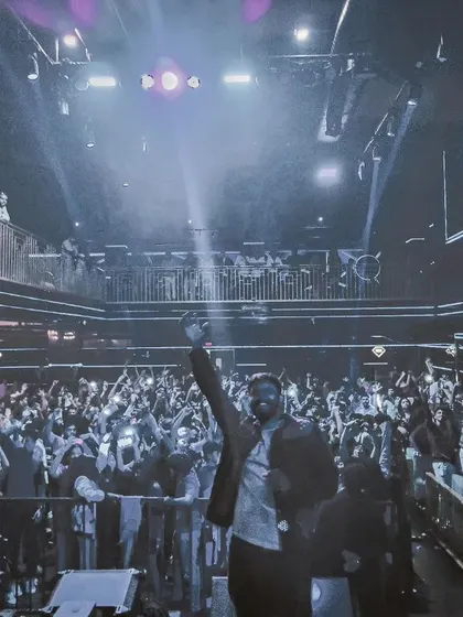 A picture of me in front of a massive club crowd with their phone lights on, creating a magical moment during a slower, more melodic part of my set.