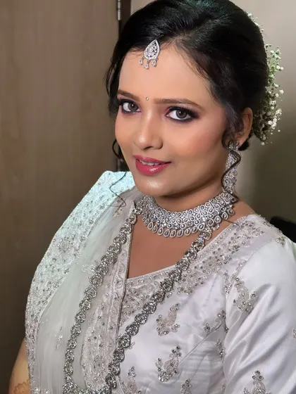 A smiling portrait of the reception look. The makeup is flawless and the diamond jewellery adds a touch of modern glamour.