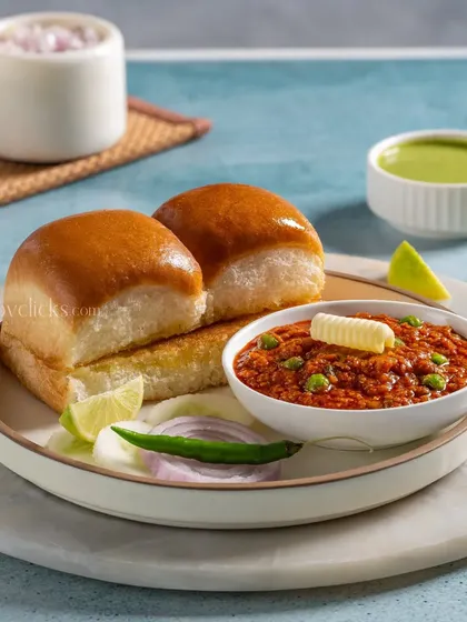 A classic Pav Bhaji, with soft, buttery pav buns and a rich, flavorful vegetable mash topped with a dollop of butter.
