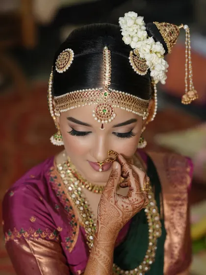 A close-up of a traditional Iyengar bridal look. Notice the precision in the eyeliner, the soft skin finish, and how the makeup perfectly complements the intricate hair jewelry. It’s all about creating a harmonious and divine look for the main ceremony.