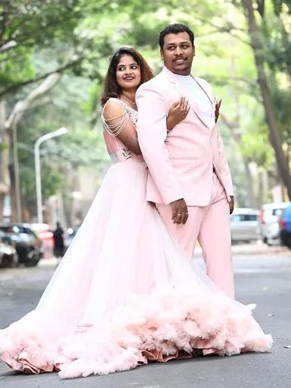 Perfectly matched in pink. This couple chose our pink ruffled trail gown and a custom-made pink suit for a fun and vibrant pre-wedding shoot.