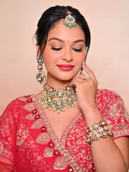 A close-up of a traditional bridal look with a red lip and softly defined eyes, created by one of my talented students.