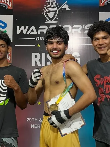 Posing with teammates after a hard-earned victory. The bond between our fighters is as strong as their punches.