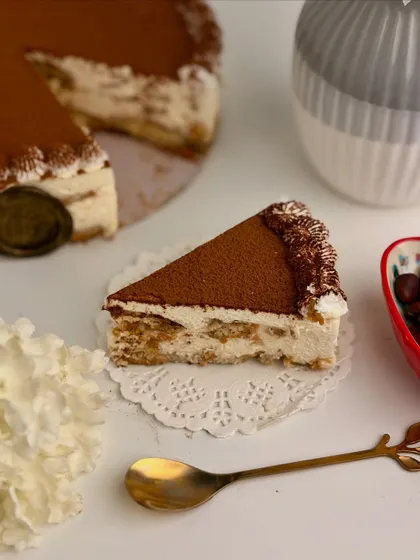A single, tempting slice of Tiramisu, ready to be enjoyed. This dessert is available by the slice or as a full cake for your special occasions.