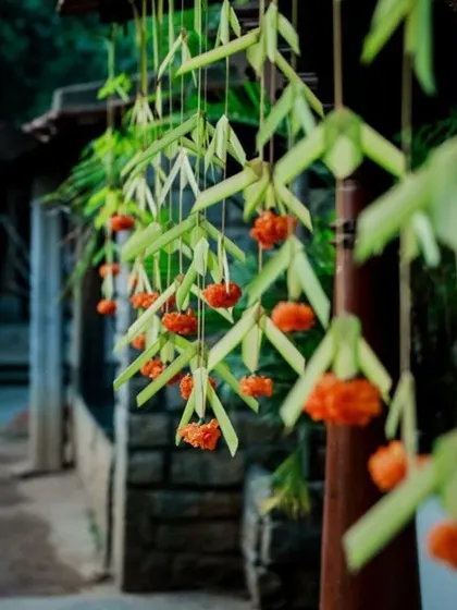 A simple yet beautiful hanging decoration made from folded palm leaves and marigold flowers.