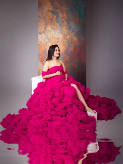 A stunning shot featuring a dramatic pink gown with a water reflection effect. This adds a layer of artistry and depth, turning a portrait into a piece of fine art.