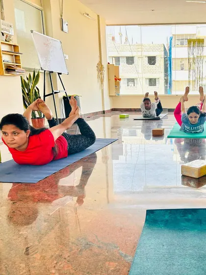 A focused moment during class as students hold a deep backbend. Regular practice helps improve spinal flexibility and relieve tension.