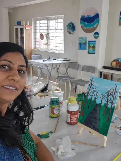 A guest taking a selfie while working on her landscape painting. Our studio is a great place to relax and get into the creative zone.